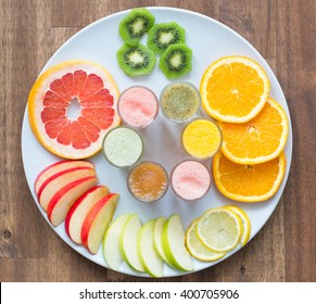 Fresh Fruit Salad Made Of Grape, Strawberry, Plum And Nectarine Served On Plate With Lemon Above, Photographed Overhead On Dark Wood With Natural Light