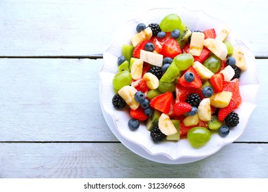 Fresh Fruit Salad On Wooden Table