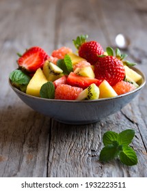 Fresh Fruit Salad With Strawberry, Pineapple, Kiwi, Ananas And  Mint.  Delicious Cut Fruit In A Bowl