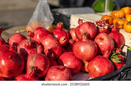 Fresh fruit stall concept, pile of pomegranate in the black box basket from farmer for sale, red fruit for texture background around the market - Powered by Shutterstock