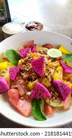 Fresh Fruit Tropical Salad Housemade With Granola, Yogurt And Berry Compote.