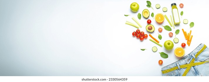 Fresh fruit, vegetables, smoothie falling into jeans and yellow measuring tape instead of belt on white background. Concept of weight loss, detox, diet, healthy clean nutrition, space for text - Powered by Shutterstock