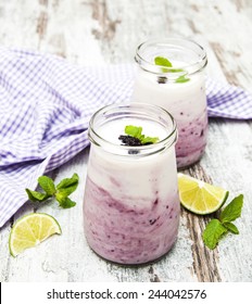 Fresh Fruit Yogurt With Blackberries And Lime On A Wooden Background