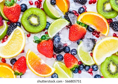 Fresh fruits background.Slices of fresh fruits top view on ice.