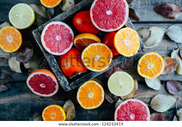 Fresh fruits. Mixed fruits background. Healthy\
eating, dieting. Background of healthy fresh fruits. Fruit salad -\
diet, healthy breakfast. pomegranate, persimmon, tangerine, banana,\
lemon