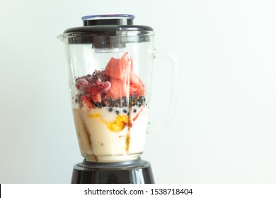 Fresh Fruits Smoothie Blender With Berries, Blueberries, Raspberries, Currants, Flattering Berries, Seeds, Mango, Peach, Avocado, Elderberry And Sesame Seeds. Smoothies Isolated With White Background