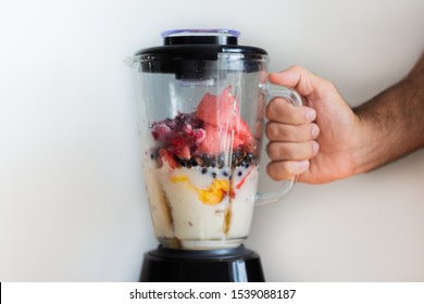 Fresh Fruits Smoothie Blender With Berries, Blueberries, Raspberries, Currants, Flattering Berries, Seeds, Mango, Peach, Avocado, Elderberry And Sesame Seeds. Smoothies Isolated With White Background