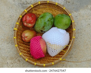 Fresh fruits in a typical Indonesian basket made from woven bamboo. - Powered by Shutterstock