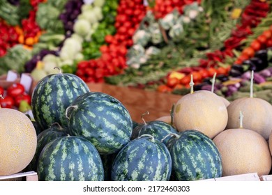 ギリシャのファーマーズマーケットで新鮮な果物や野菜。カラフルな季節の野菜の背景にスイカとメロンを販売。健康的な食事、健康的なライフスタイルのコンセプト。
