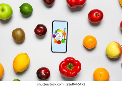 Fresh fruits, vegetables and mobile phone with text WORLD VEGAN DAY on grey background - Powered by Shutterstock