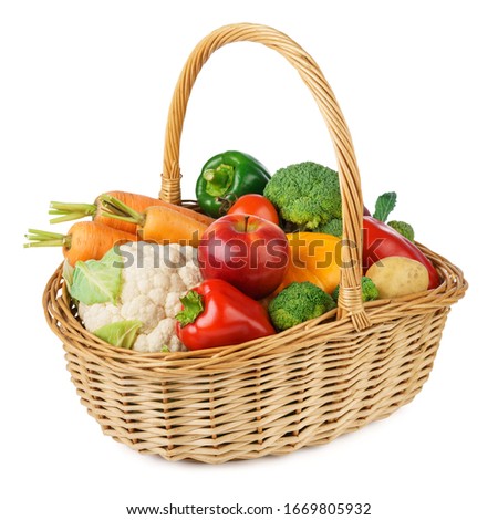 Fresh fruits and vegetables in a wicker basket. Isolated on white background.