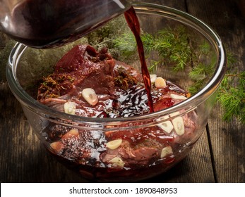 Fresh game meat marinated in red wine sauce with wild herbs and garlic