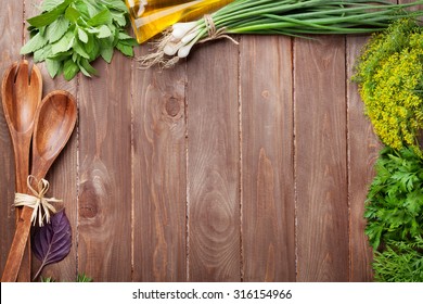 Fresh garden herbs on wooden table. Top view with copy space