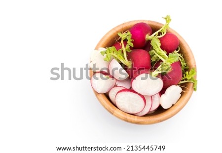 Fresh garden red radishes and sliced ​​radishes in a wooden bowl. isolated on white, top view