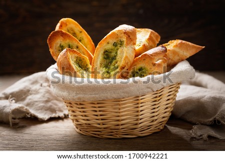 fresh garlic bread with herbs in a wooden basket