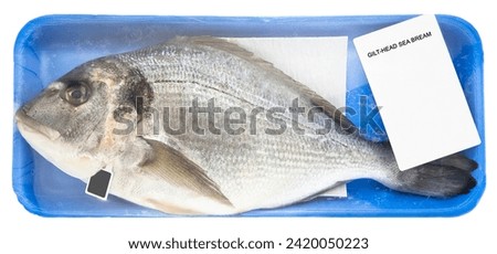 Fresh gilthead bream fish inside a plastic tray with cellophane cover packaging