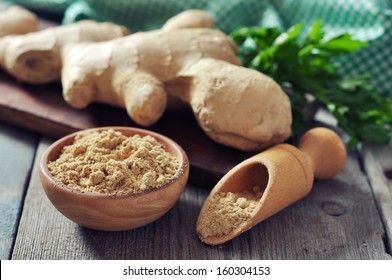 Fresh Ginger Root And Ground Ginger Spice On Wooden Background