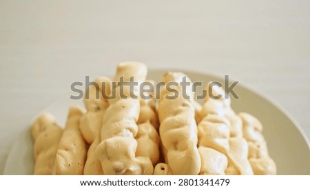 Fresh ginger root on a white plate, healthy food ingredient, natural setting.