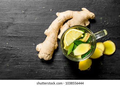 Fresh ginger tea with lemon. On the black chalkboard.