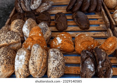 Fresh grain handmade bread in different shapes, sizes and colors. Organic food and health. Close-up.