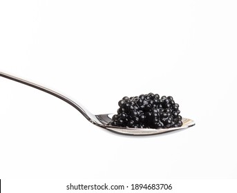fresh grainy black paddlefish caviar in metal spoon on white background, close up