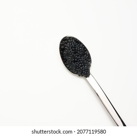 Fresh Grainy Black Paddlefish Caviar In Metal Spoon On White Background, Top View