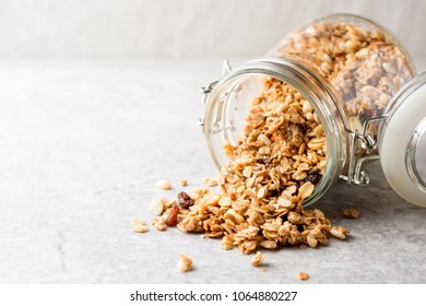 Fresh granola in glass jar on gray stone background. Selective focus. Copy space. - Powered by Shutterstock