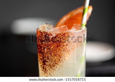 fresh grape and lime alcohol cocktail at a restaurant interior 