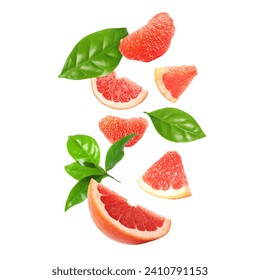 Fresh grapefruit pieces and green leaves falling on white background