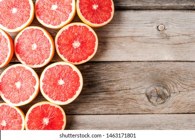 Fresh grapefruits on wooden background with copyspace