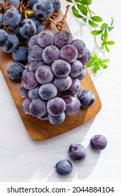 Fresh Grapes On Wooden Table