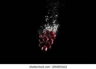 fresh Grapes with water bubbles. the concept of freshness of berry in water. underwater fruit photo with isolated black background - Powered by Shutterstock