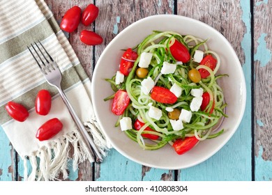 Fresh Greek Salad With Cucumber Noodles, Overhead Scene On Rustic Wood Background