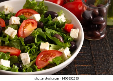 Fresh Greek Salad With Olives Tomatos And Feta Cheese On A Rustic Wood Table