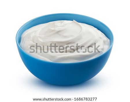 Fresh greek yogurt in blue bowl isolated on white background with clipping path