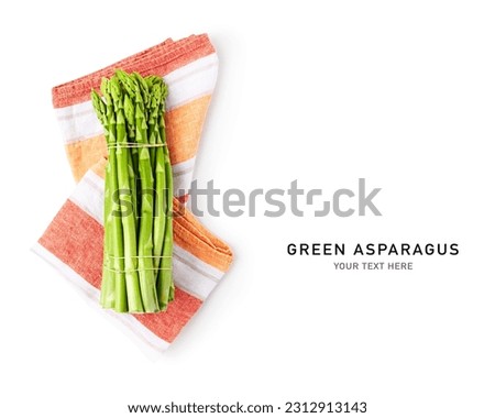 Fresh green asparagus bunch and kitchen cloth isolated on white background. Creative layout. Healthy eating and dieting food concept. Design element. Top view, flat lay
