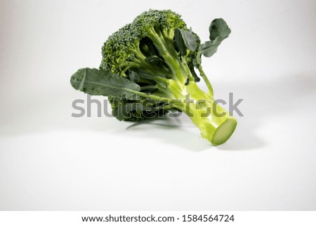 Similar – Small pieces of raw broccoli on white wood, Close up