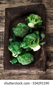 Fresh green broccoli in wood bowl over rustic wooden background ,healthy or vegetarian food concept