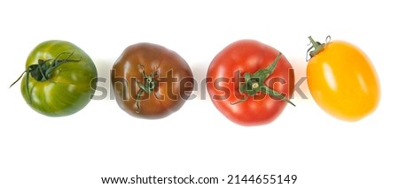 Fresh green, brown, red and yellow tomatoes isolated on white background, top view