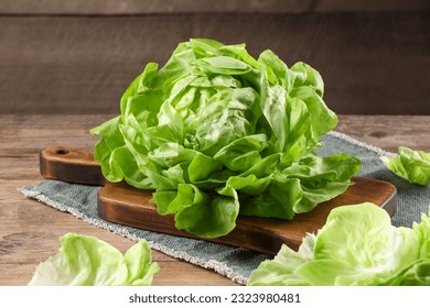 Fresh green butter lettuce on wooden table, closeup - Powered by Shutterstock