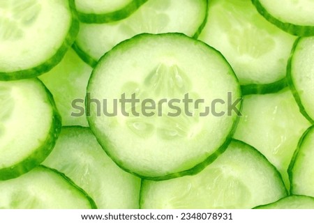 Fresh green cucumber slices close up top view.