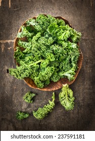 Fresh Green Curly Kale In Wooden Dish On Dark Background, Top View