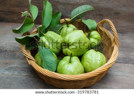 Fresh green guavas on old wood background.