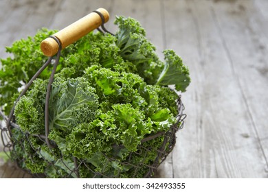 Fresh green kale leaves on wooden table - Powered by Shutterstock