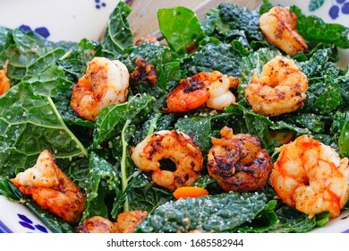 Fresh Green Kale Salad With Blackened Shrimp In A Bowl