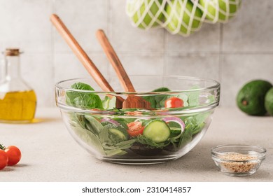 Fresh green lettuce leaves mix in glass bowl. Cooking healthy and delicious food. Diet food concept - Powered by Shutterstock