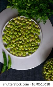 Fresh Green Lima Beans Stacked Together On A White Plate With Selective Focus