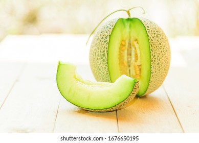 Fresh Green Melon On Wood Plate