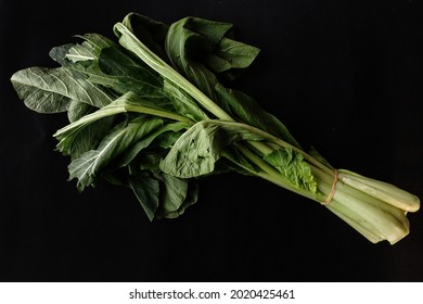 Fresh Green Mustard Greens Isolated On Black Background