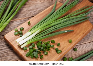 Fresh green onions on a cutting board. 